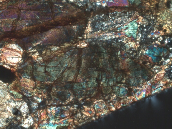 Deformed (showing mosaic extinction) olivine in the Morrow County (CML 0497) chondrite (L6 S5 W1).